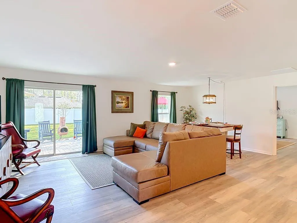Family room -luxury vinyl flooring View to dining room and sliders to outdoor oasis