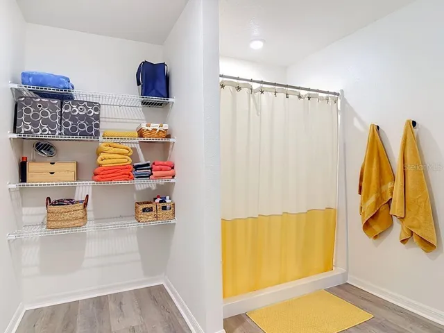 Primary en-suite bathroom/ walk in shower- extended vanity - walk in closet - open linen area