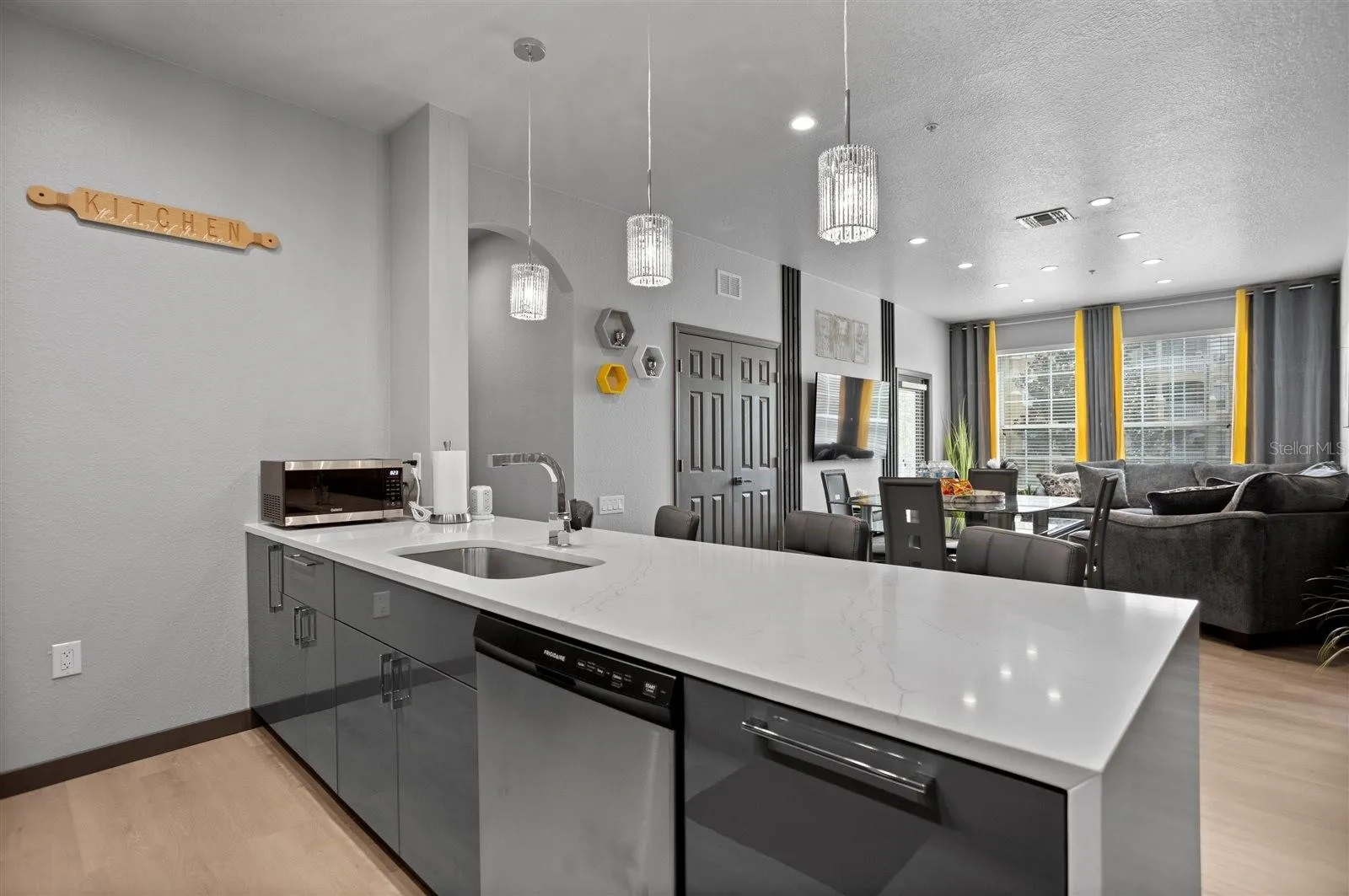 Waterfall quartz countertops create a sleek, contemporary centerpiece