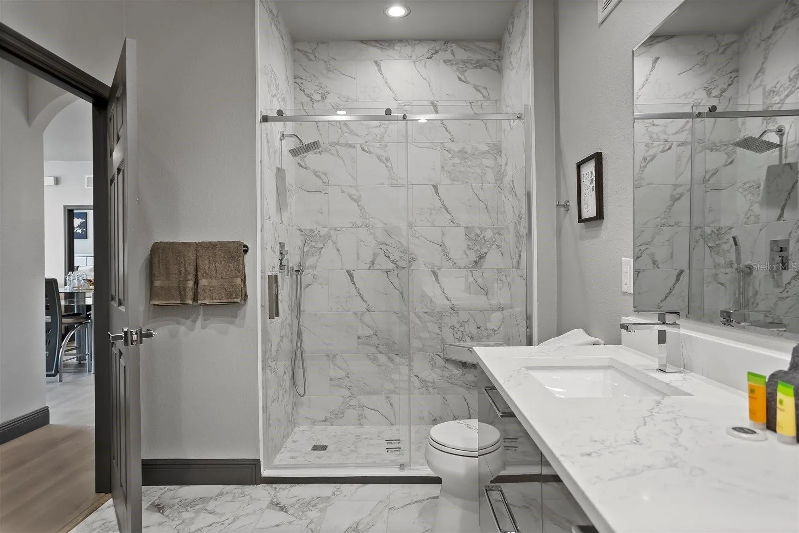 Updated guest bathroom featuring modern tile and a spacious walk-in shower