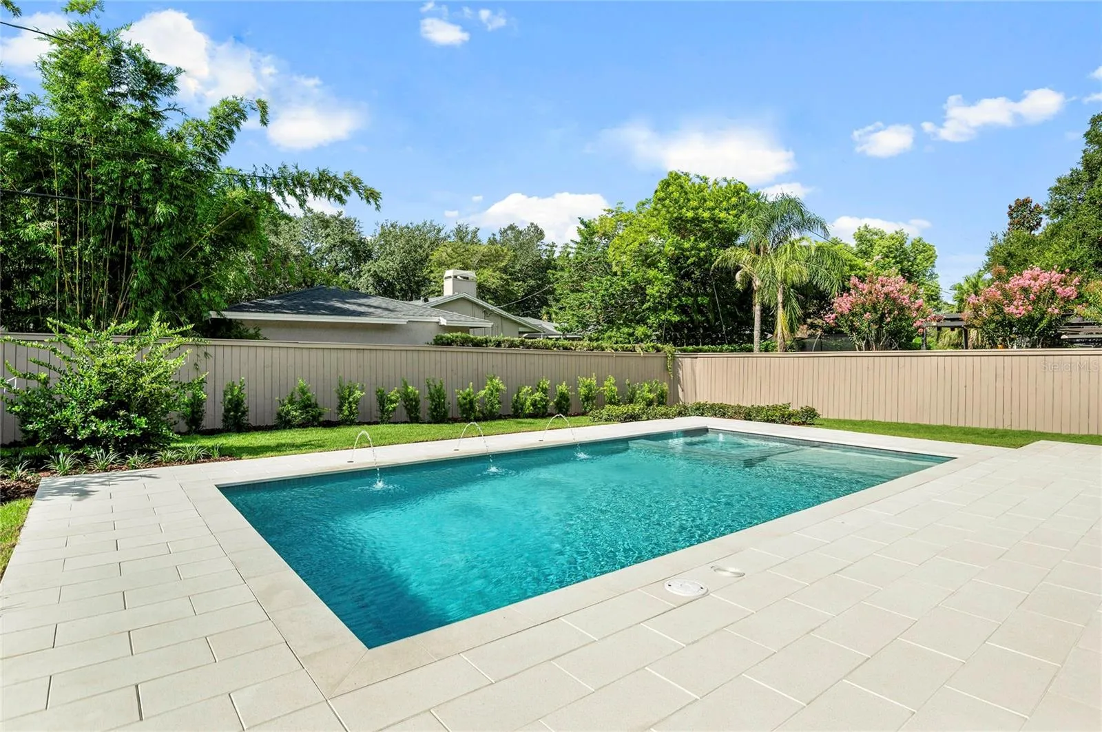 Saltwater Pool with integrated Spa & Sunshelf along with deck mounted water feature
