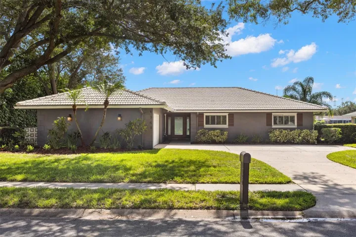 Lakefront living takes center stage at this beautifully maintained Morningside home, where a screened saltwater pool, expansive outdoor living spaces and wide Stewart Lake views create a setting that feels distinctly Florida.