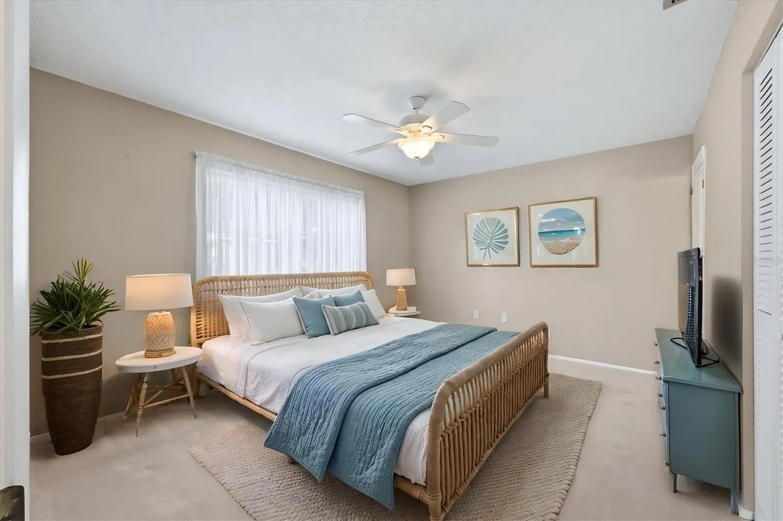 staged primary bedroom has large closet not shown