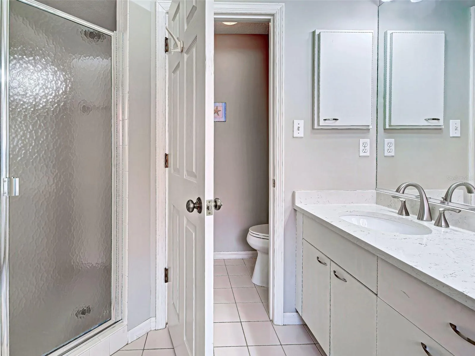 Primary bathroom showing shower and water closet.