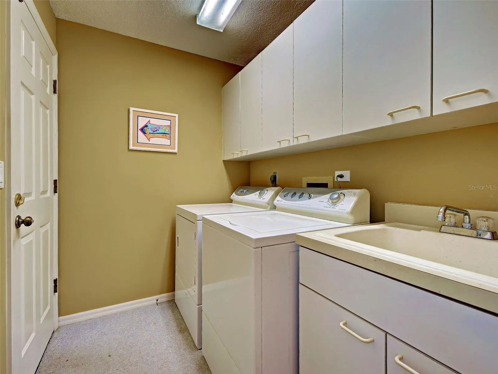 Laundry room showing door to garage.