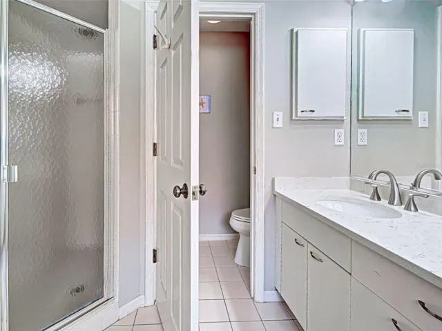 Primary bathroom showing shower and water closet.