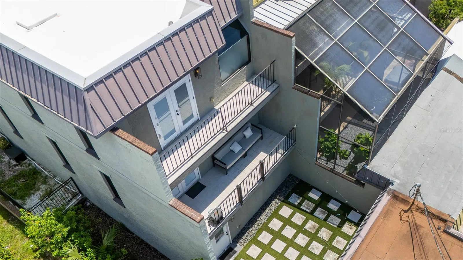 The neighbor enclosed the lower level, creating two additional bedrooms.