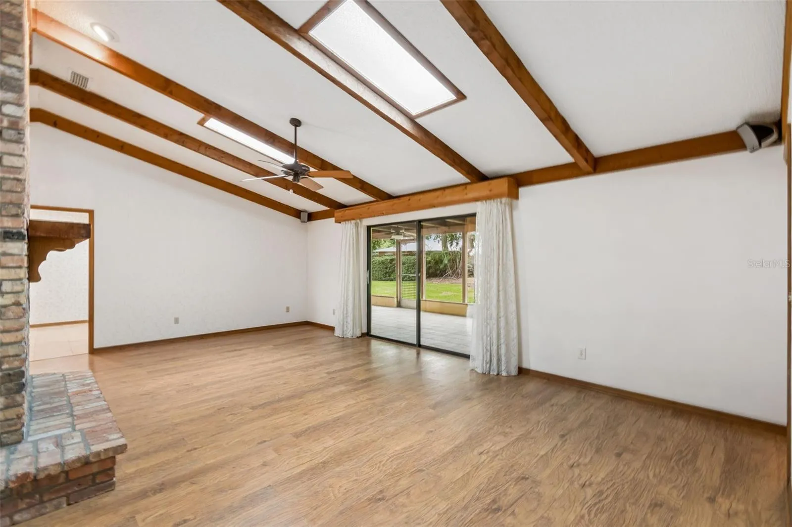 Vaulted ceiling with skylights and accent wood beams