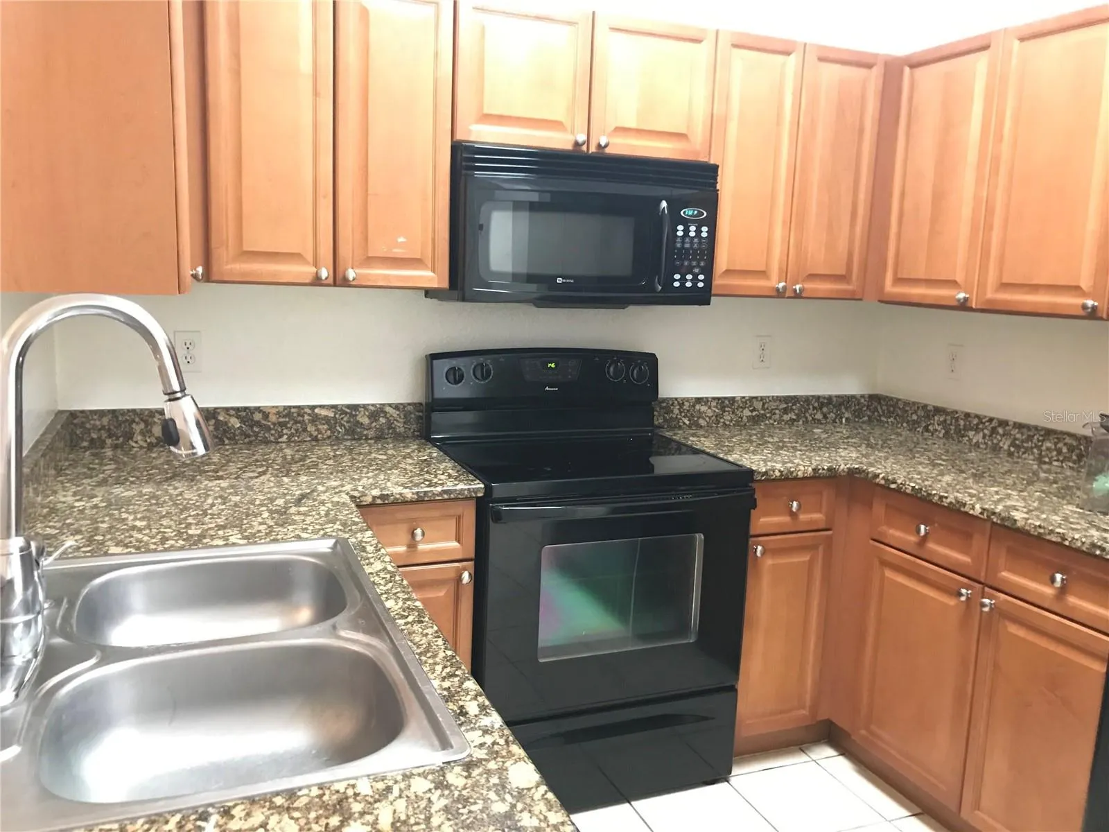 Kitchen with double sink and gooseneck faucet.