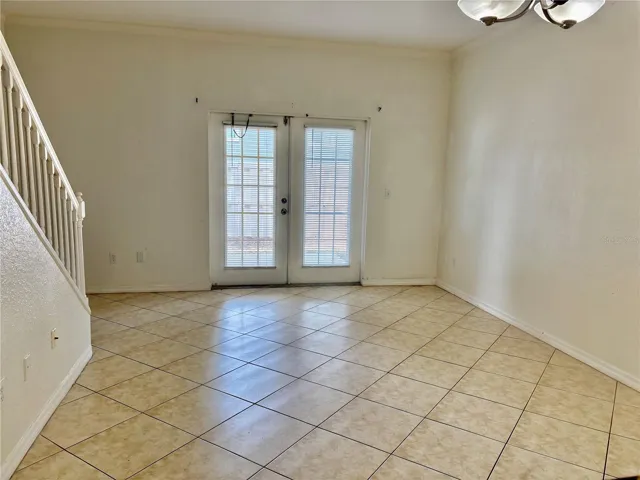 Great room with French doors and stairs at left.