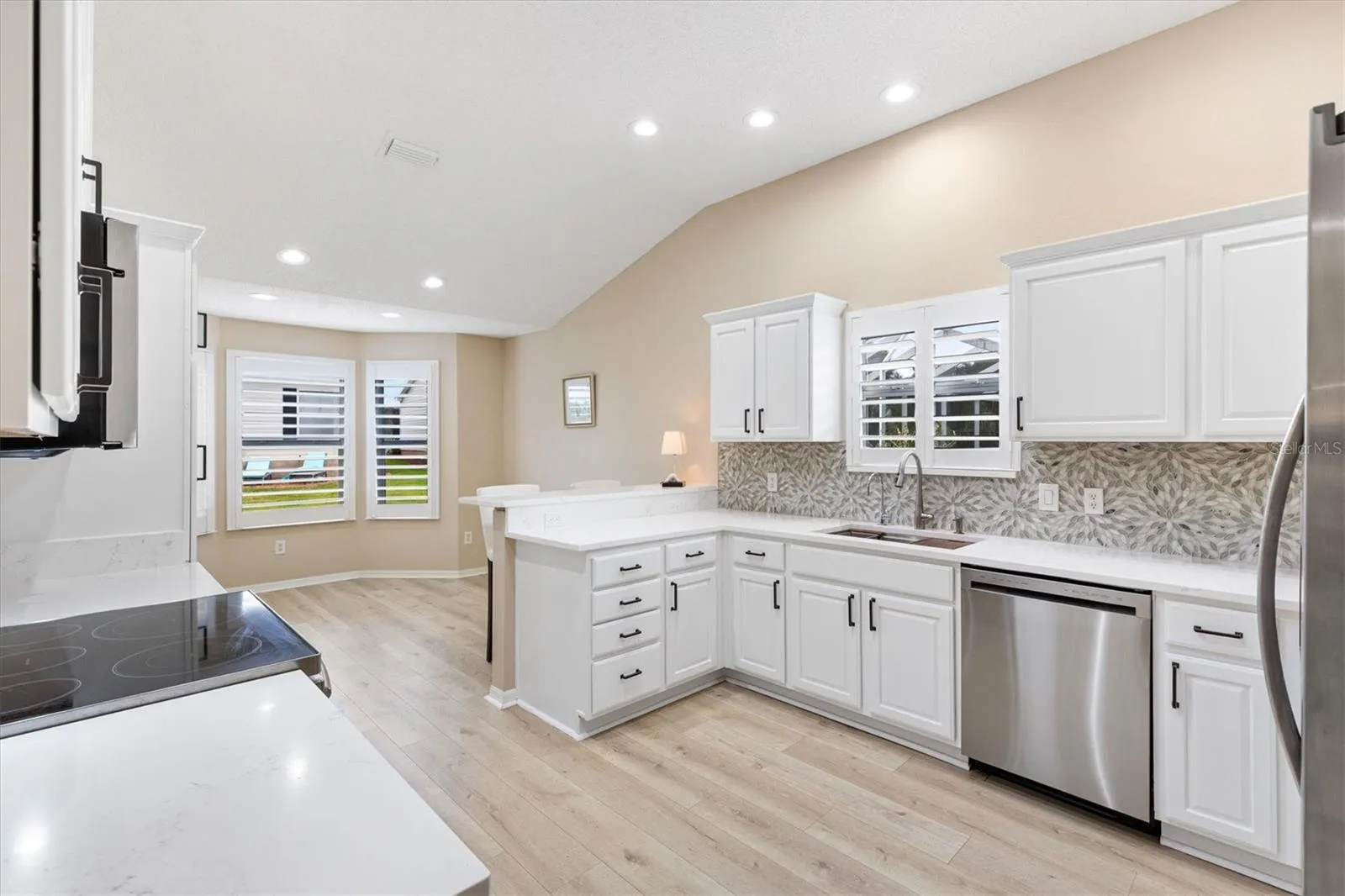 NEW KITCHEN: PLANTATION SHUTTERS, PAINTED CABINETS w/NEW HARDWARE, QUARTZ COUNTERTOPS, GLASS TILE BACKSPLASH, NEW DISHWASHER, NEW LED LIGHTING