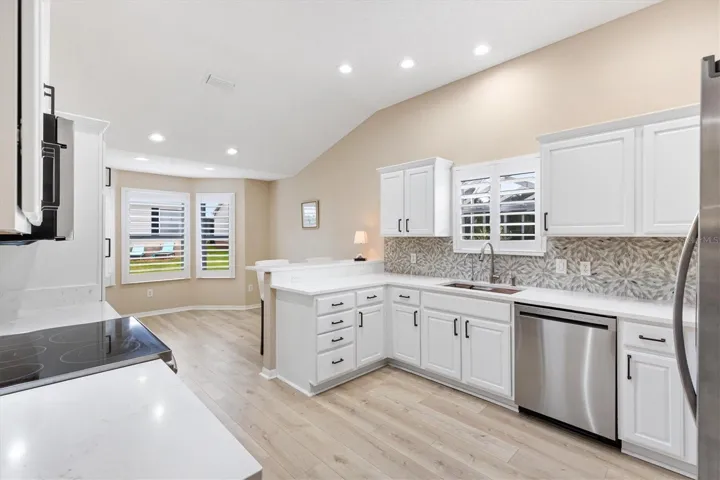 NEW KITCHEN: PLANTATION SHUTTERS, PAINTED CABINETS w/NEW HARDWARE, QUARTZ COUNTERTOPS, GLASS TILE BACKSPLASH, NEW DISHWASHER, NEW LED LIGHTING