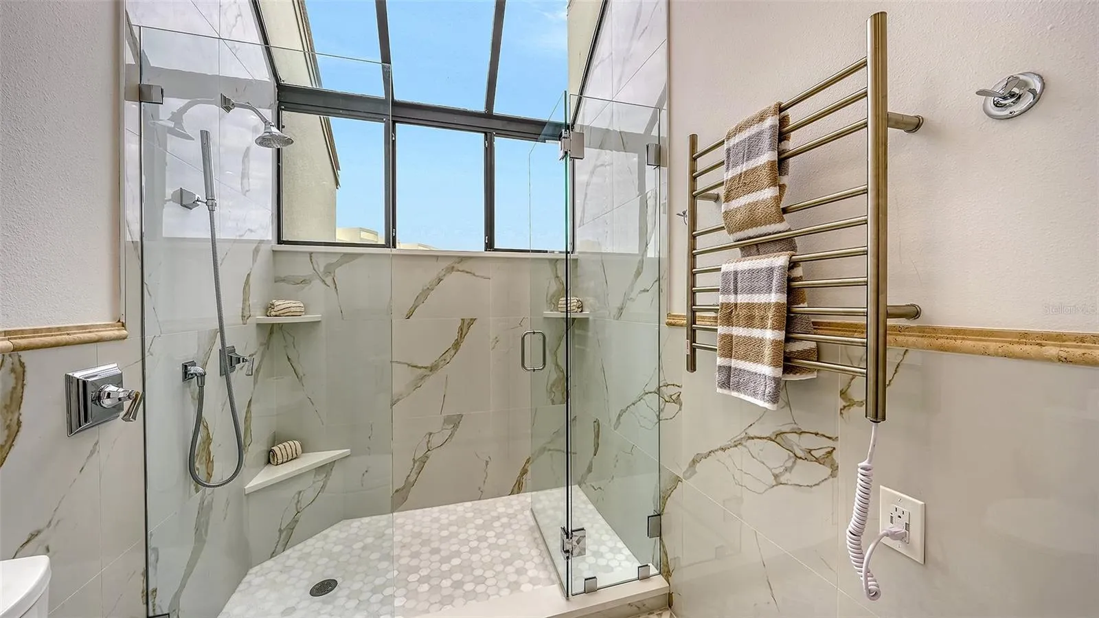THE TOWEL WARMER W/ THE GARDEN WINDOW IN THE PRIMARY BATHROOM