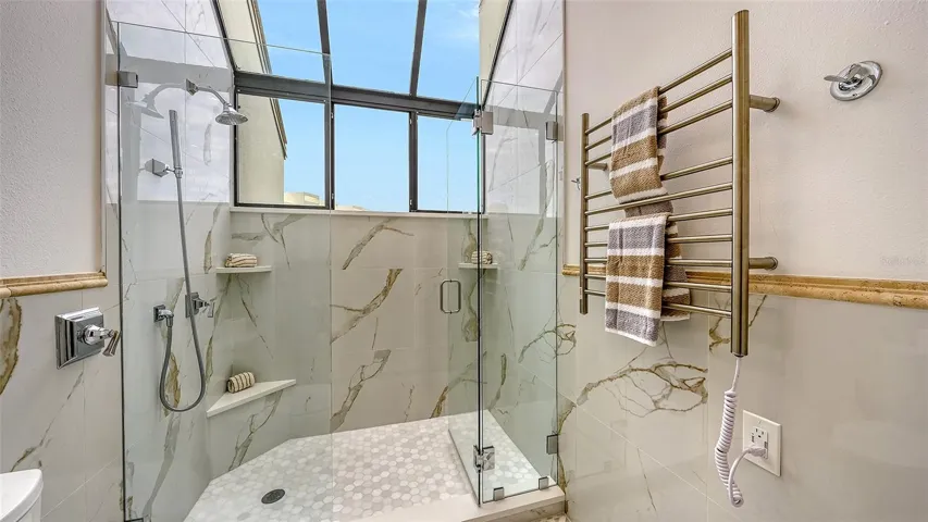 THE TOWEL WARMER W/ THE GARDEN WINDOW IN THE PRIMARY BATHROOM