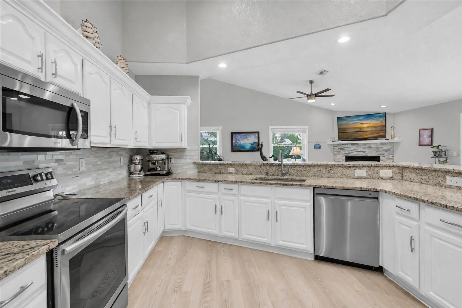 Light &amp; bright kitchen offering abundant counter space &amp; generous cabinetry for plenty of storage.