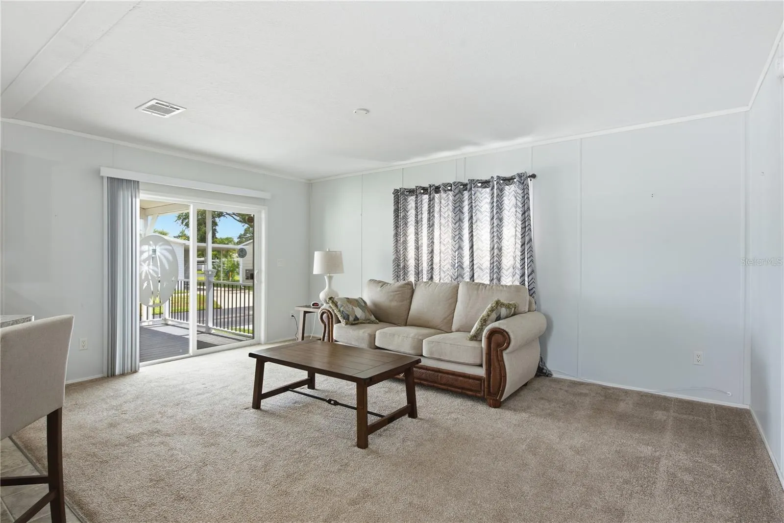 Living room with sliding doors to spacious, covered front porch