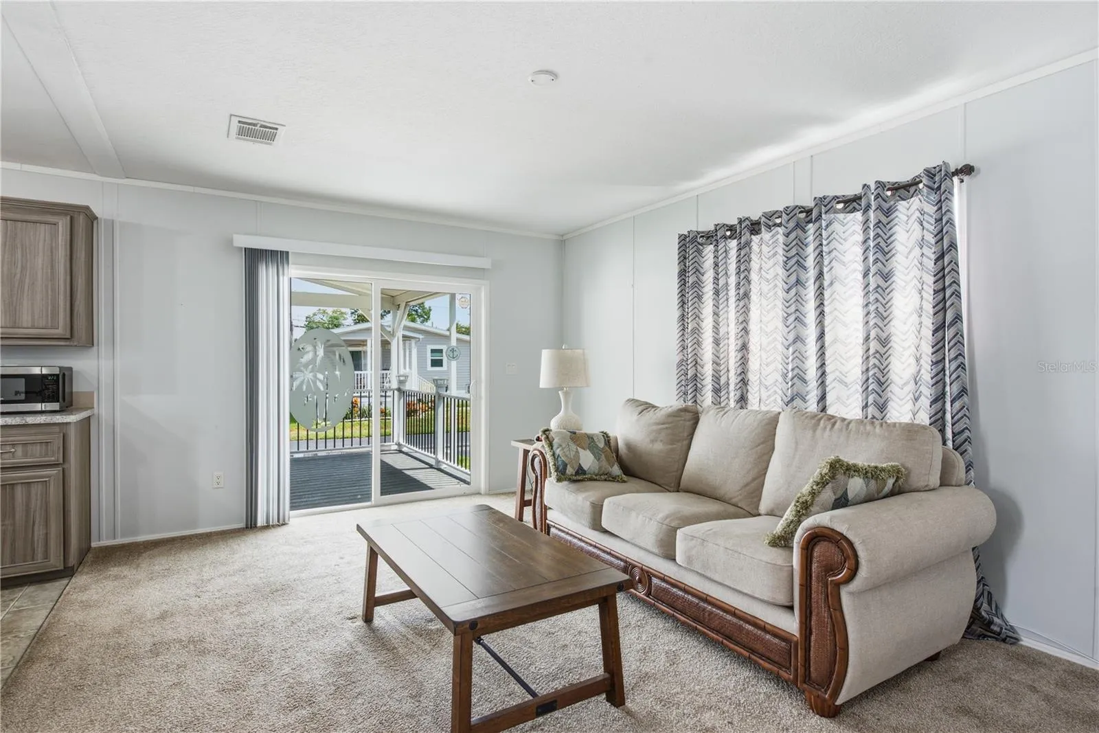 Living room with sliders to the spacious covered front porch