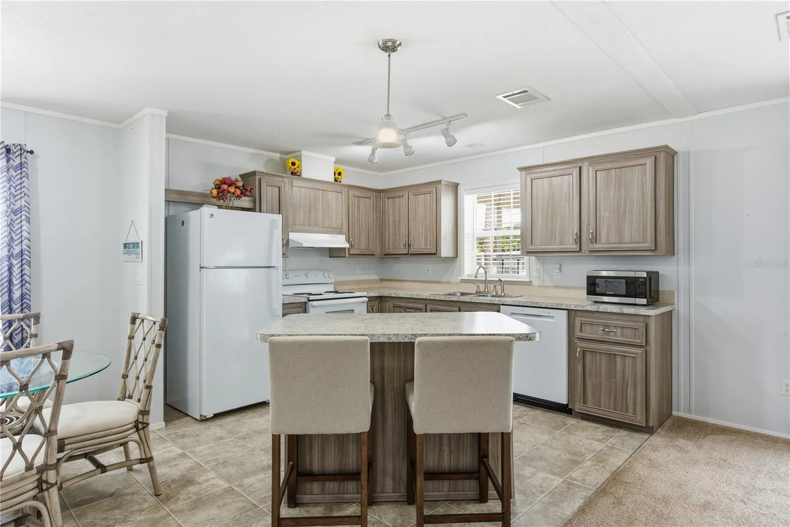 Kitchen with bar top island and dining room