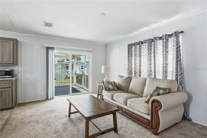 Living room with sliders to the spacious covered front porch