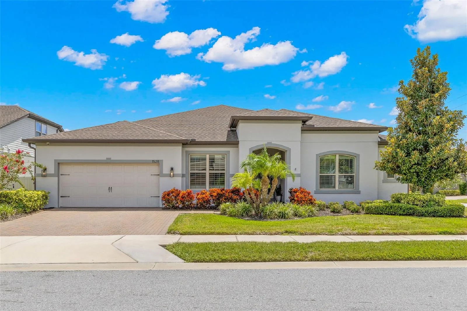 A polished first impression in gated Enclave at Palm Harbor: this single-story 3-bedroom, plus den/Flex room, 2½-bath pool home offers 2,965 square feet, a brick-paver driveway, two-car garage, arched covered entry and beautifully maintained tropical landscaping.