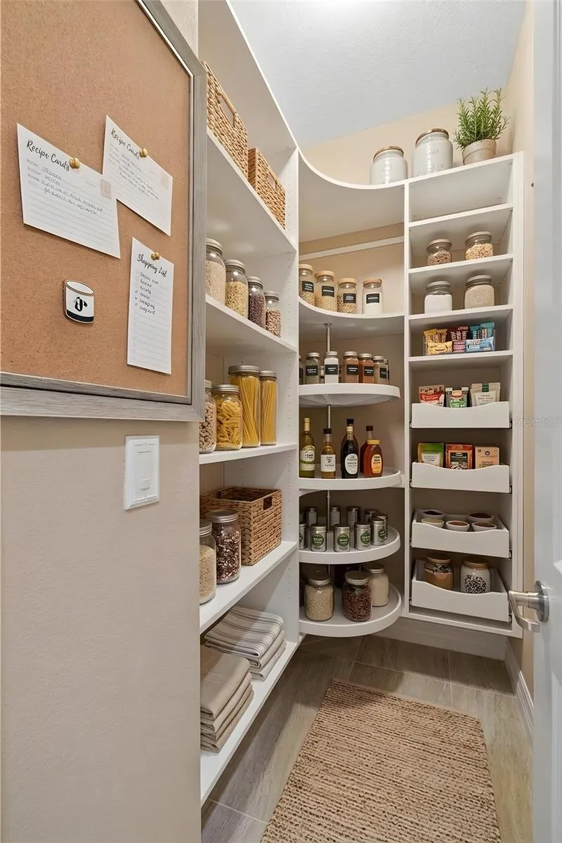 Even the pantry gets thoughtful attention, with a walk-in design, built-in shelving, pull-out storage and a corner Lazy Susan that makes excellent use of every inch. There’s even a convenient spot for shopping lists, recipes and the inevitable “don’t forget the coffee” reminder.