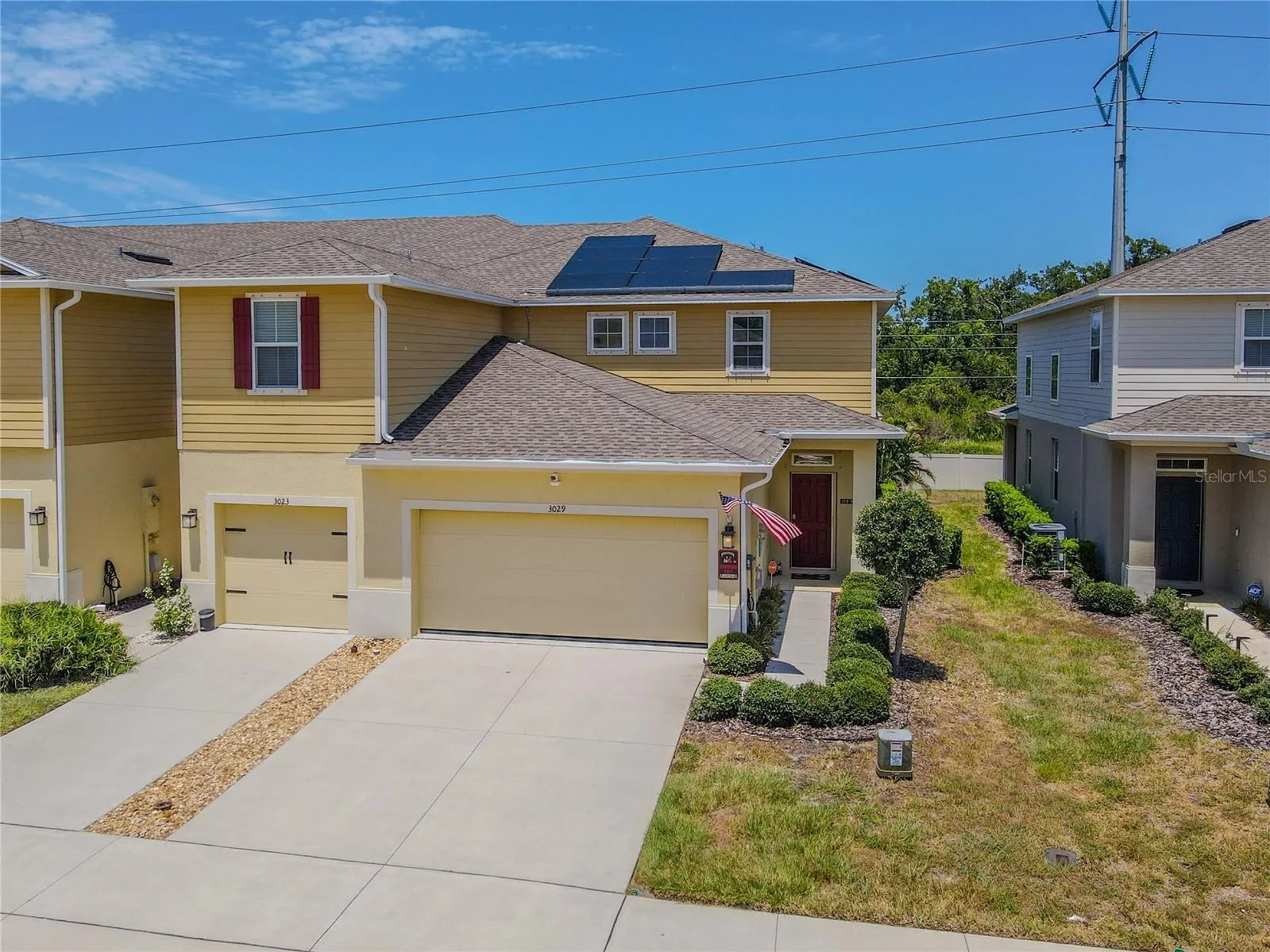End-unit positioning, an attached 2-car garage, rooftop solar panels and a landscaped side entry give the home strong curb appeal, with added separation along the side creating a more open setting than many townhomes offer.