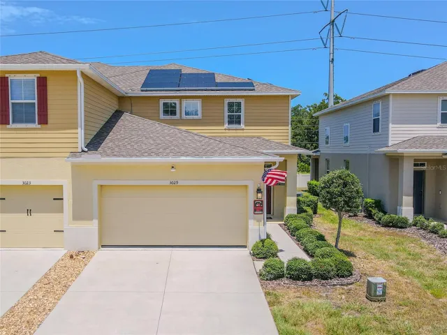 End-unit advantage! A wide driveway and attached 2-car garage introduce this 2021-built townhome, with rooftop solar and additional outdoor space along the side of the home.