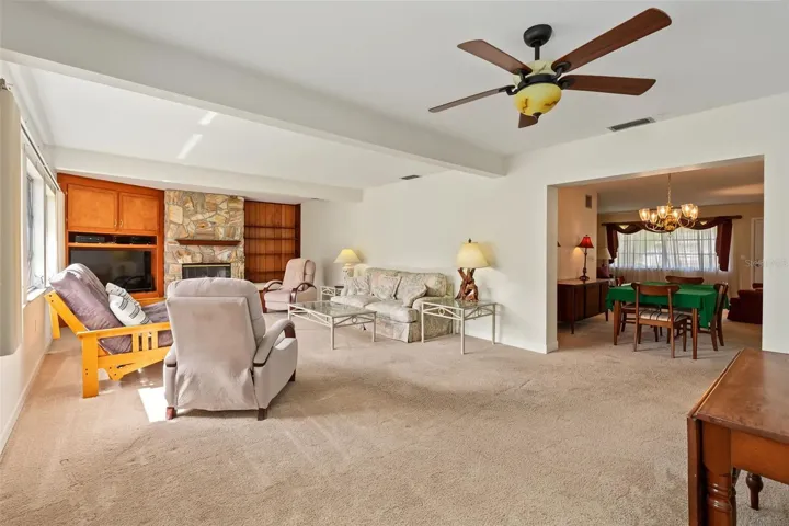 Large family room with a wood burning fireplace.