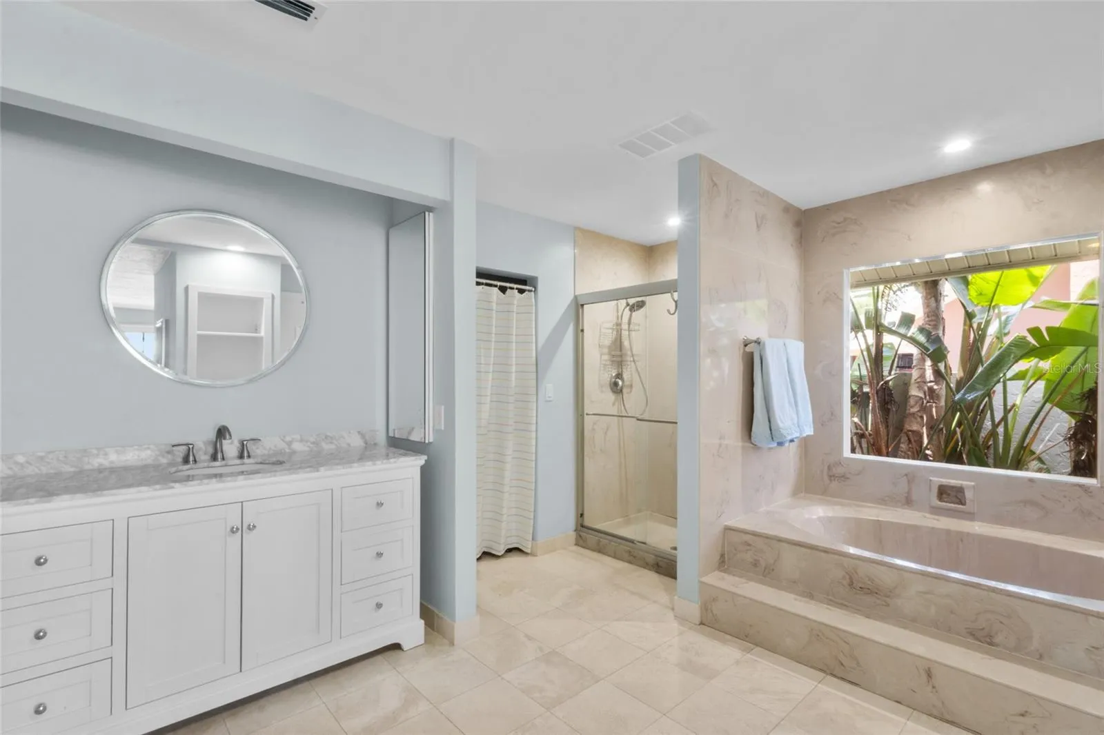 The primary bathroom houses 2 walk in closets and 1 large storage area.