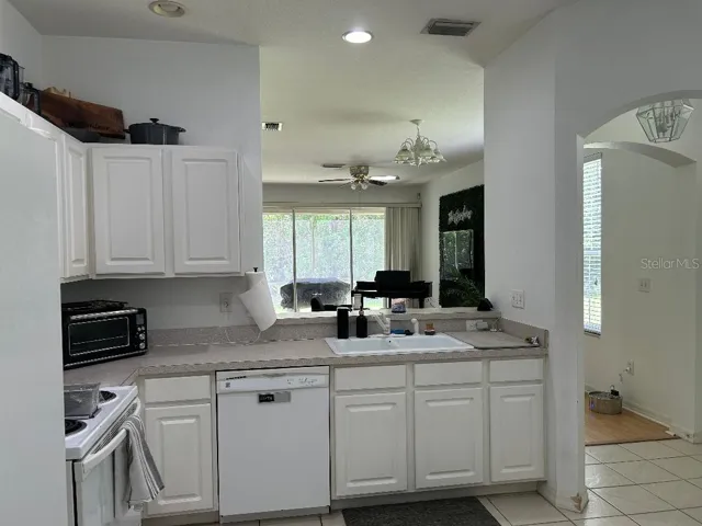 Kitchen with brekfast bar opens to LR?DR to lanai
