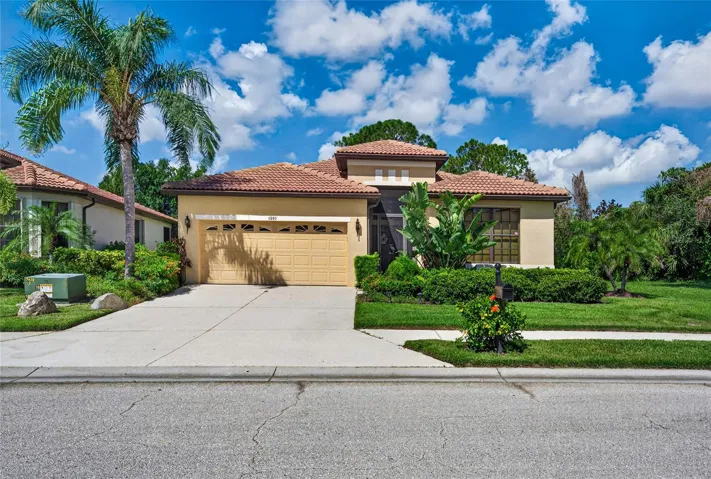 Paver block driveway enhances front of this home