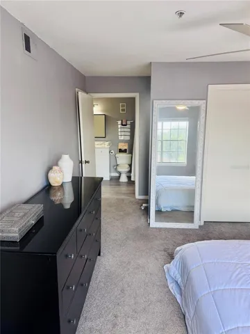 Door off primary bedroom with vanity area leading into main bath