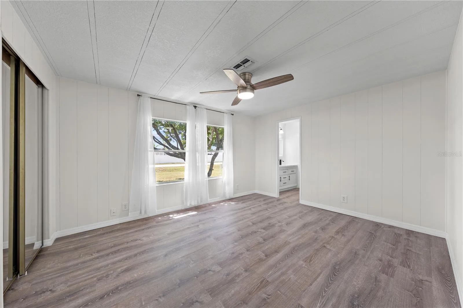 Primary bedroom with a front yard view