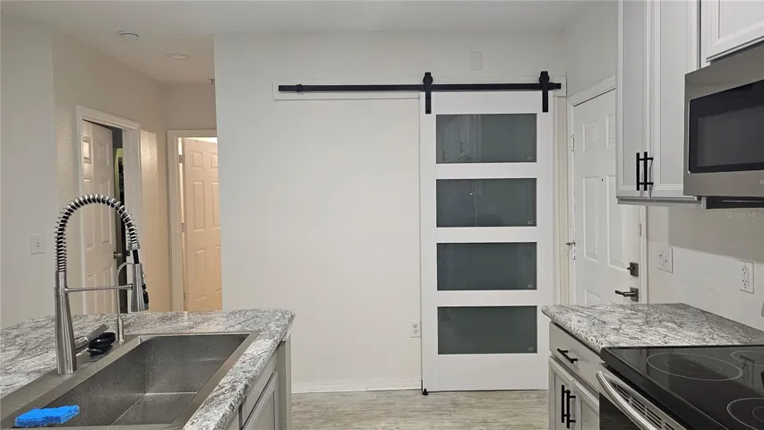 Laundry room with barn door