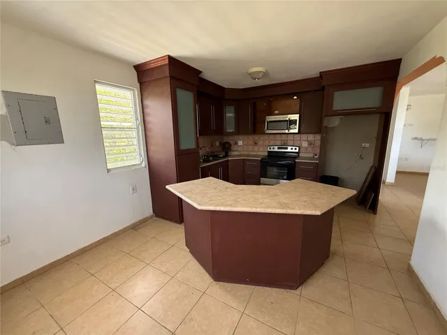Cocina con gabinetes de madera e isla central / Kitchen with wood cabinets and center island