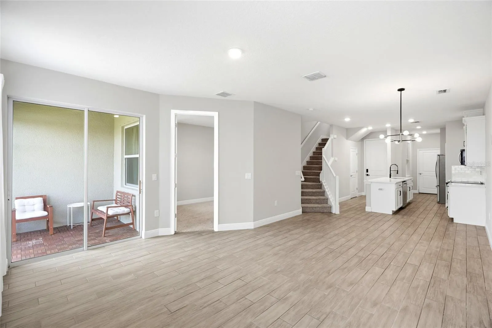 Living area access to the patio and primary bedroom on the main floor