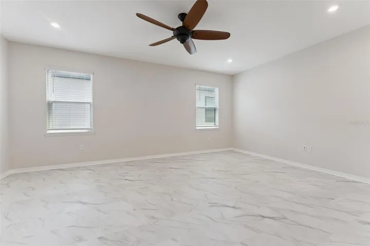 Bonus Room – A second angle highlights the generous open floor area and multiple windows that bring natural light into this versatile upstairs retreat.