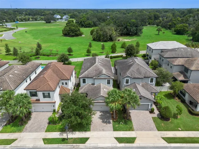 1287 Verdant Glade Pl, showcasing an attractive two-story exterior, paver driveway, and a standout setting with expansive green space directly beyond the backyard.