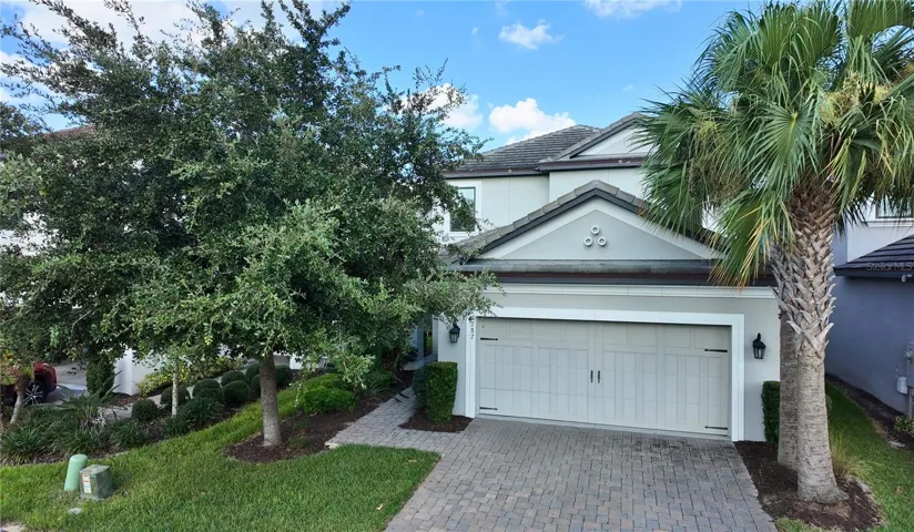 Front entry with paver driveway and two-car garage