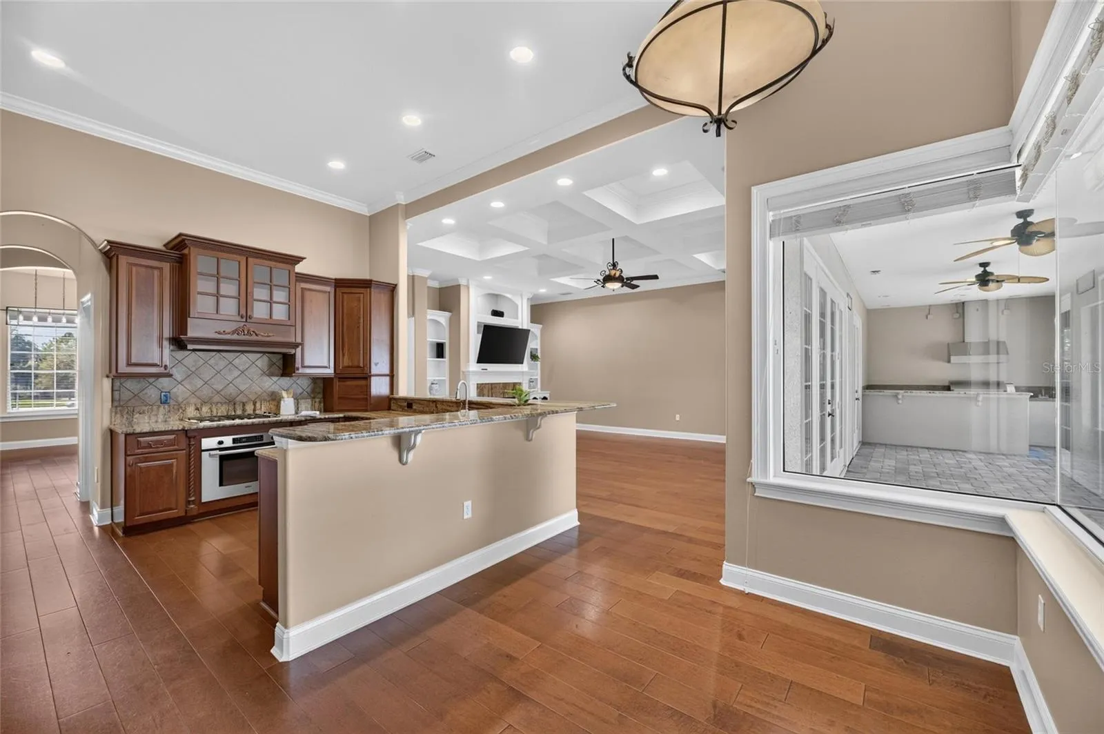 Beakfast area nook off kitchen with huge seamless windows that overlook the backyard