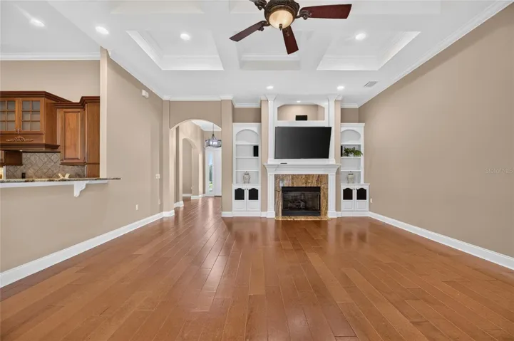 Gas Fireplace, Sound System and custom cabinetry with beautiful coffered ceiling