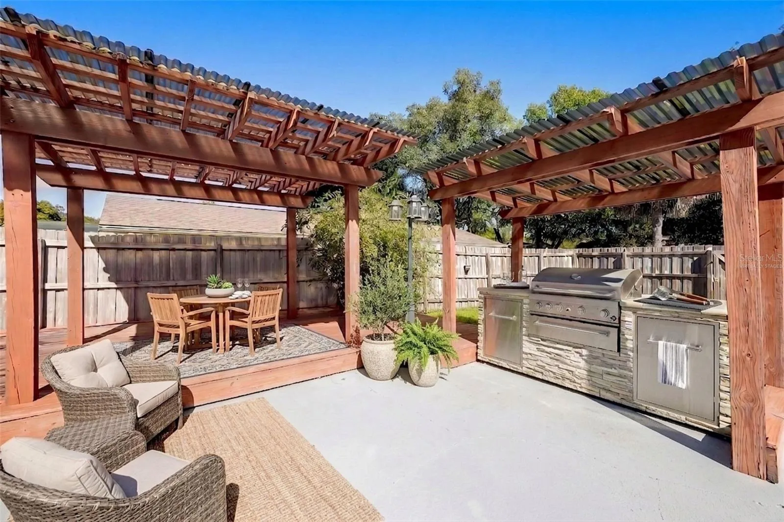 Outdoor pergola and grilling area - virtually staged