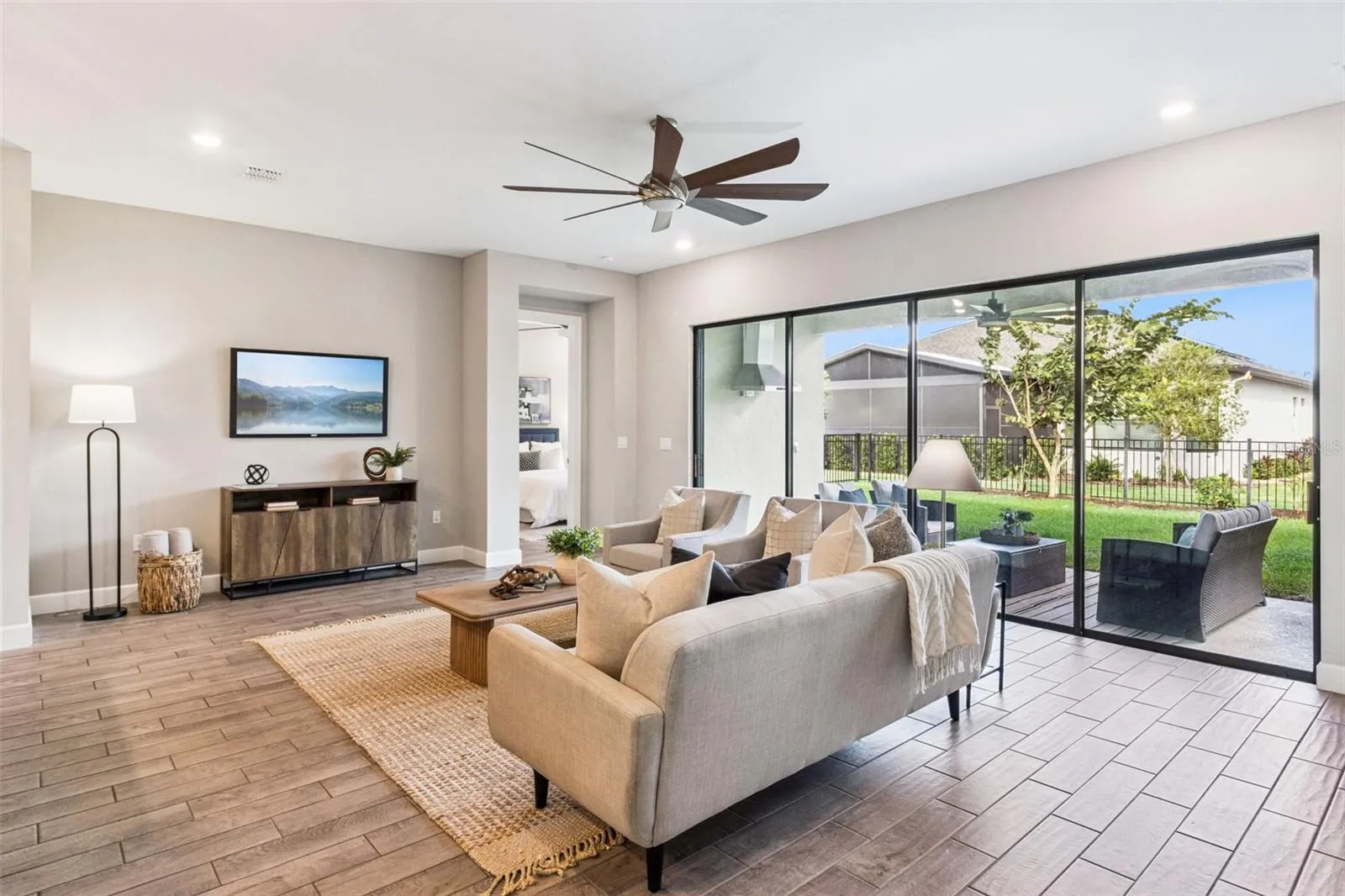 Living room with sliding glass doors and relaxing backyard views in Solivita, Poinciana.