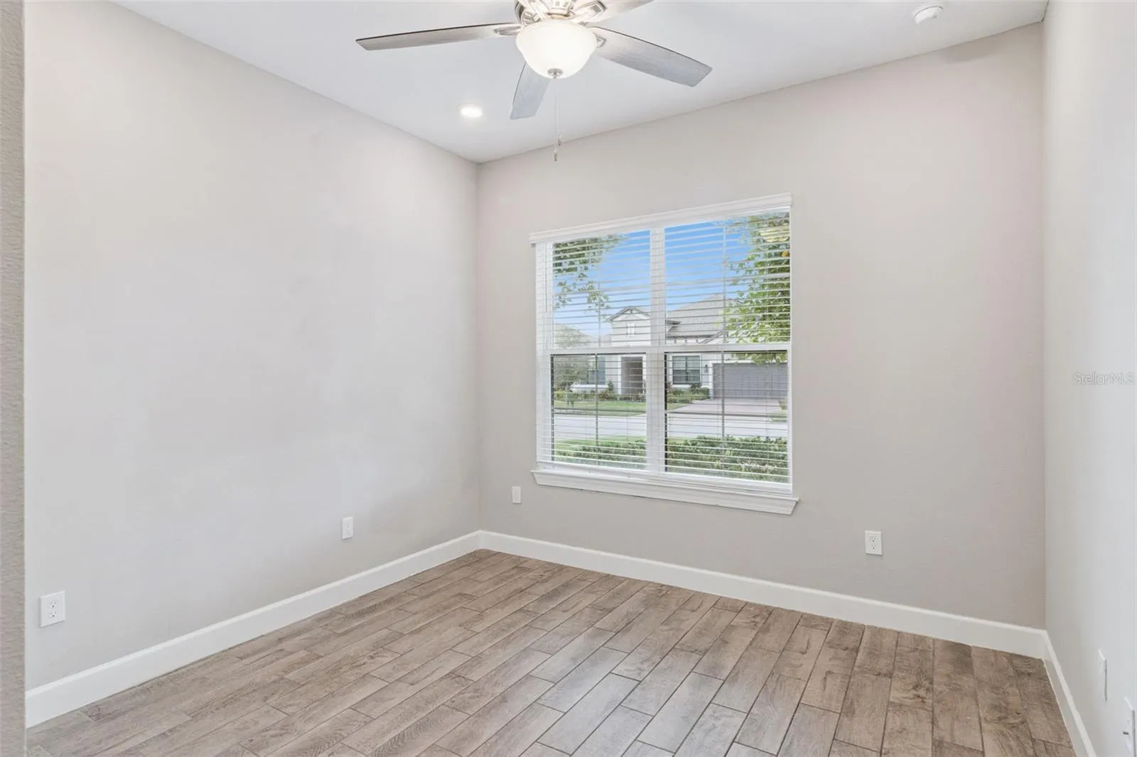 Third bedroom with ceiling fan, ideal for guests, a home office, or hobbies.