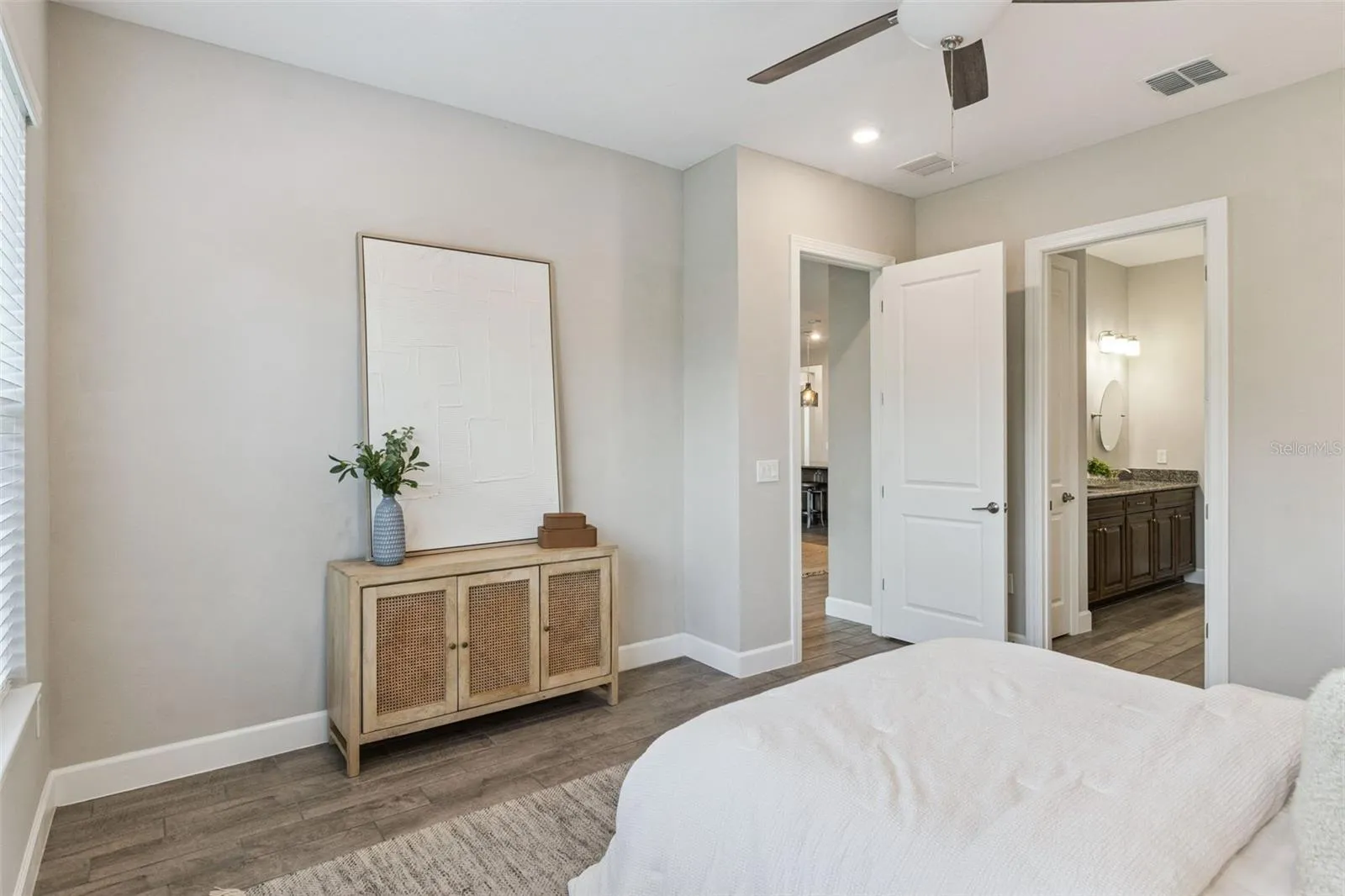 Second primary bedroom with neutral finishes and view toward the hallway.