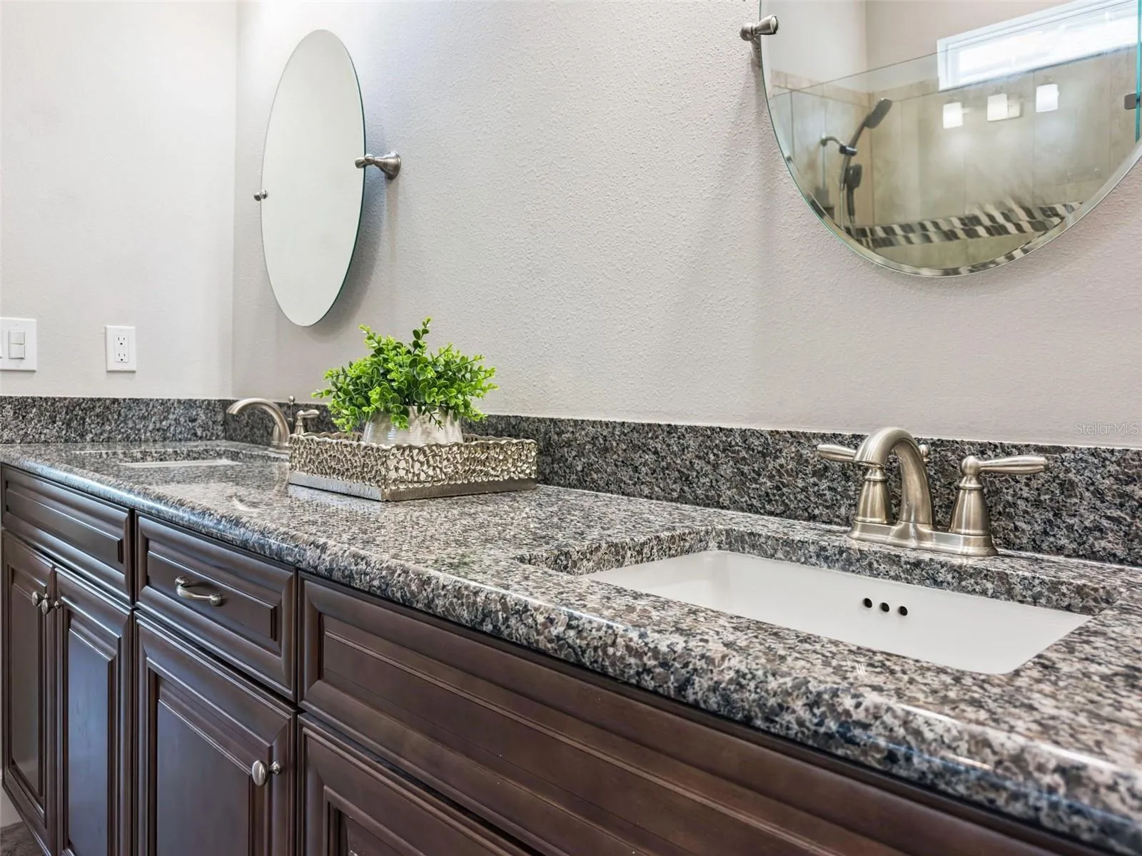 Bathroom vanity with granite countertop and modern fixtures.