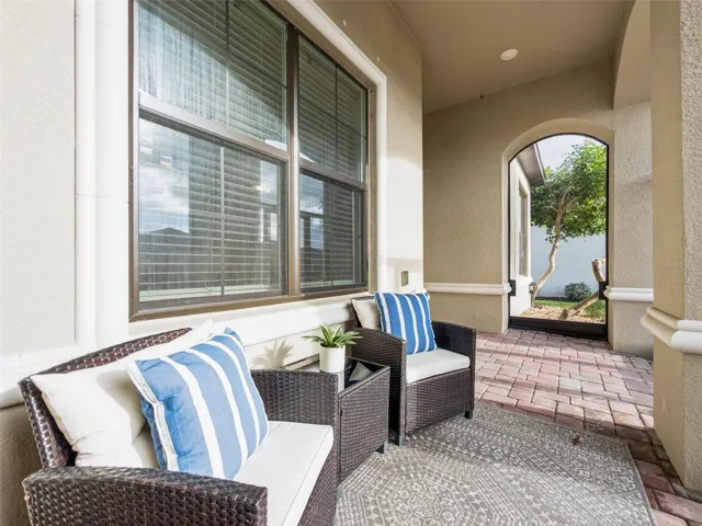 Screened front porch with seating, a welcoming place to relax and enjoy the Florida lifestyle.