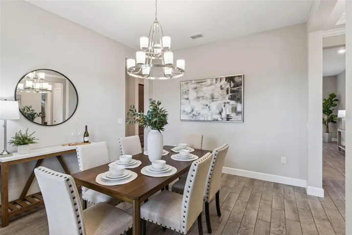 Dining room with chandelier, ready for holiday dinners and everyday meals.