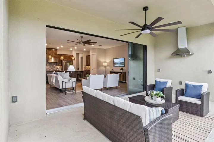Covered patio with ceiling fan flowing into the open living area, perfect for enjoying Central Florida's year round sunshine.