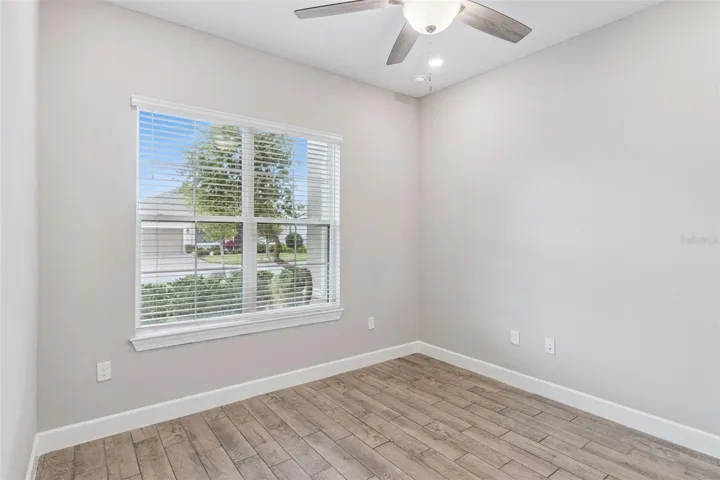 Third bedroom with large window, a flexible space for guests or a home office.